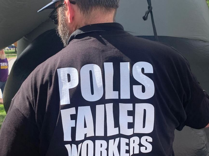 T-shirts say Gov. Jared Polis failed union workers at a rally at the state Capitol in Denver. (Colorado Politics file)