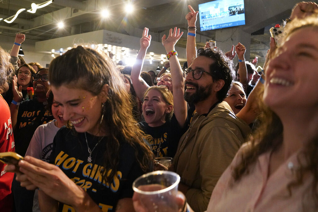 Supporters cheer as the second round of results come in with Democratic congressional candidate Melat Kiros leading during an election night watch party at The Broadway, Tuesday, June 30, 2026, in Denver. (AP Photo/Rebecca Slezak)