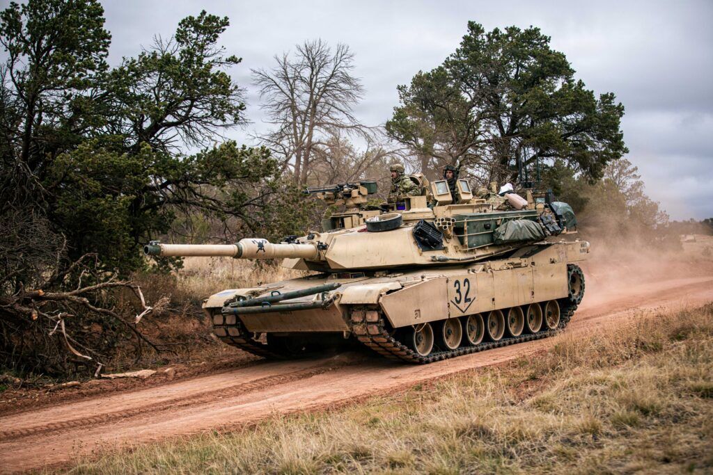 A tank drives down a road.