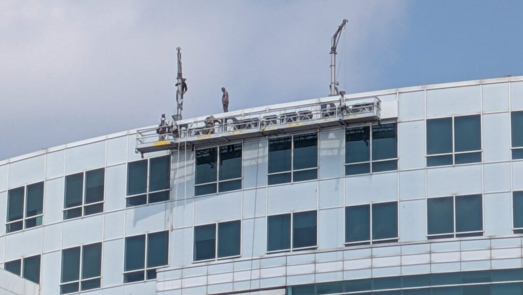 Workers remove the Denver Post sign from it's former building at 101 W. Colfax Ave., Denver, on Wednesday, June 24, 2026.