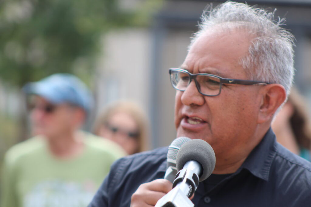 Monsignor Jorge de los Santos speaks at a July 23, 2026, news conference announcing a lawsuit over the proposed ICE detention center in Hudson.