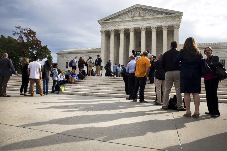 In this Tuesday, Oct. 13, 2015 file photo, people line up outside of the Supreme Court in Washington, D.C. (Jacquelyn Martin, The Associated Press)