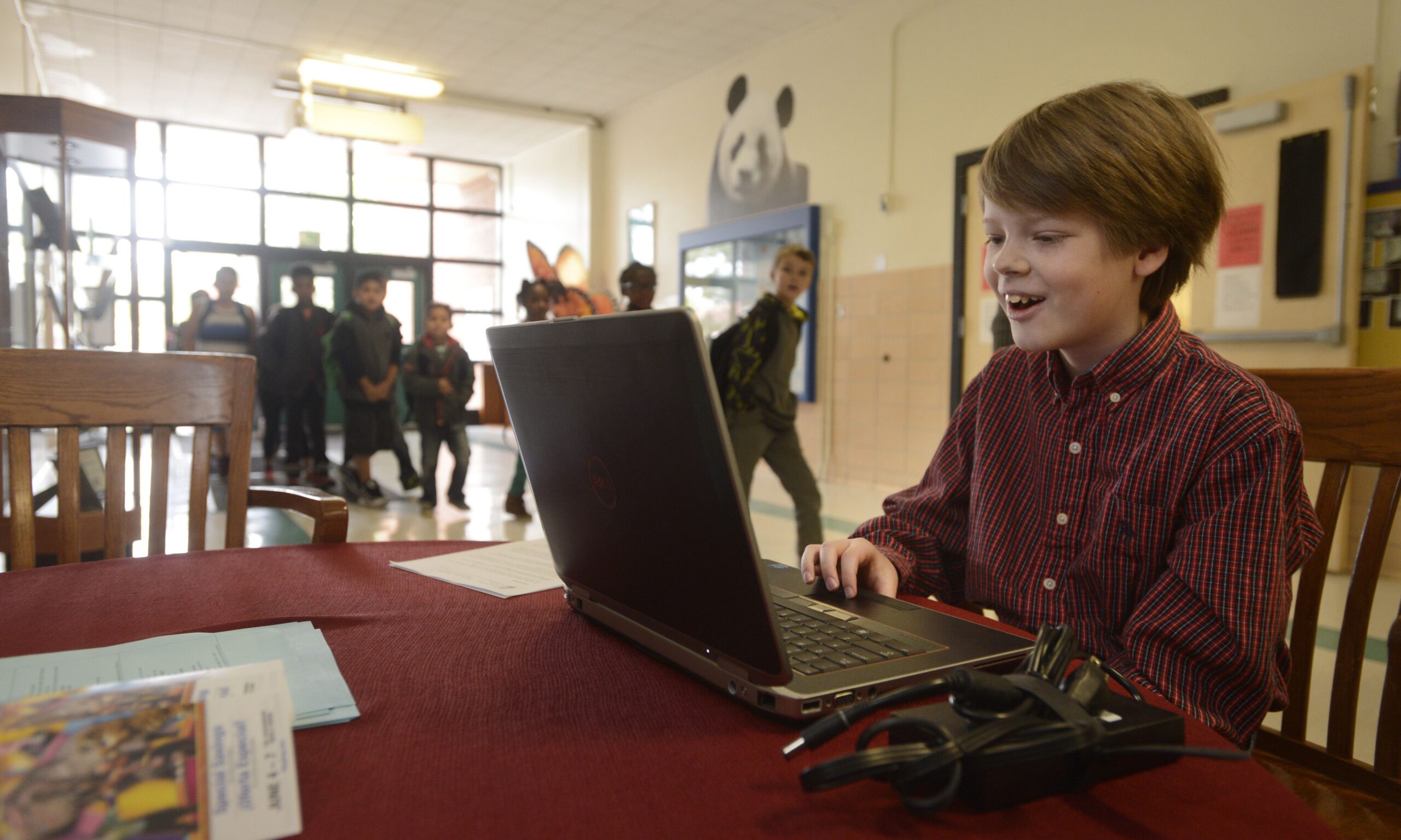 Queen Palmer Elementary School fourth grader Oliver Owens tries out the free computer that was given to his family Wednesday, May 13, 2015. (Mark Reis, The Gazette)