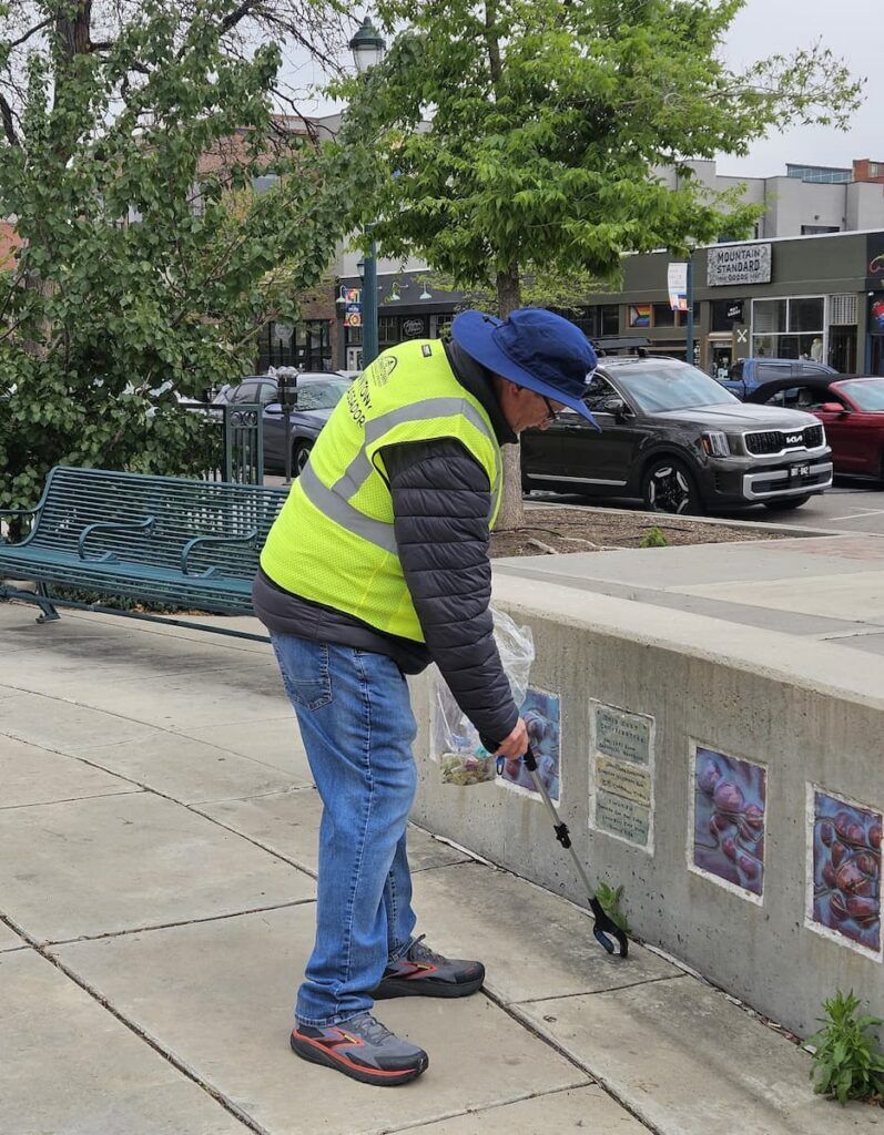 Downtown Ambassador Paul Kavanaugh picks up trash on the streets as part of his job of keeping downtown safe, clean and orderly, and assisting homeless people with their needs.