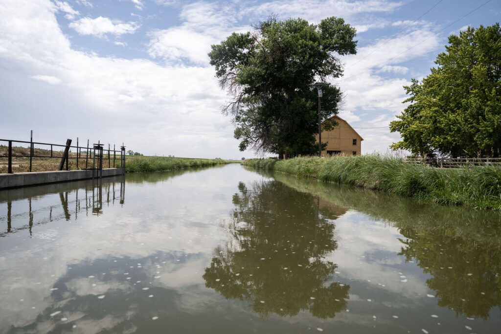 An irrigation stream, fed by a nearby reservoir, runs between farms in Eaton on Thursday, July 23, 2026. In normal years the stream runs 5-7 days a week all summer. This year it has only run 4 days a week in June and august and 5 days a week in July, and will run at least two weeks shorter than usual.
