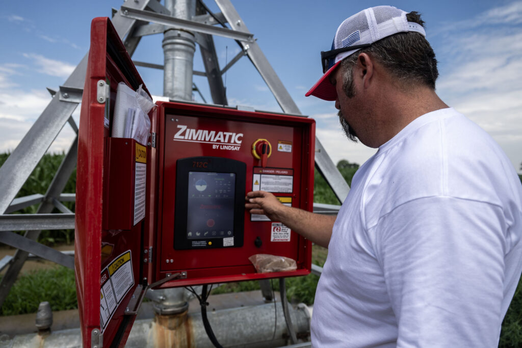 Jim Magnuson, a fourth generation farmer in Eaton, operates the control panel on one of his center-pivot sprinklers on a corn field in Eaton on Thursday, July 23, 2026.