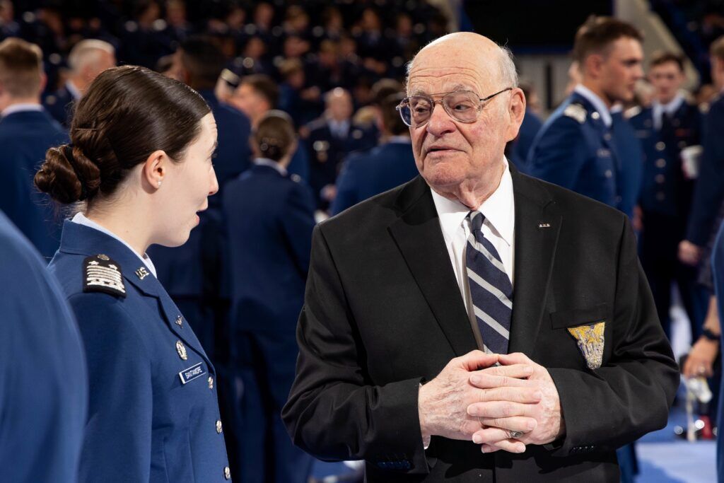 Retired Col. Max Miller talks with Jane M. Santamore who ranked first in military performance among the class of 2026. Miller presents the award to those receiving the Military Order of Merit each year. Courtesy Air Force Academy