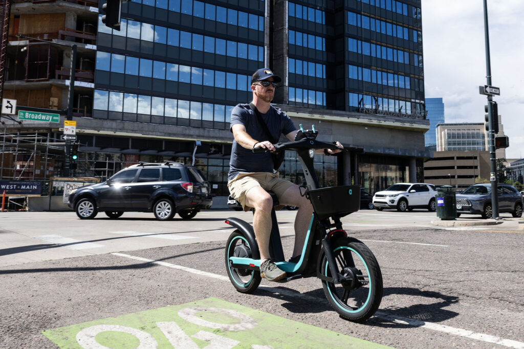 A man rides a Veo E-bike through downtown Denver on Thursday, Aug. 27, 2026.