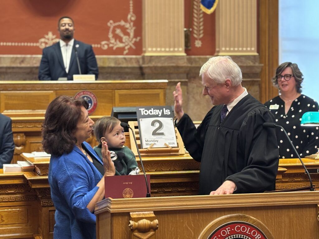 Sen. Adrienne Benavidez, D-Adams County, is sworn into office on Monday, March 2 by Court of Appeals Judge Lino S. Lipinsky de Orlov. She's holding her grandson, Teotl. Photo courtesy Senate Democrats.