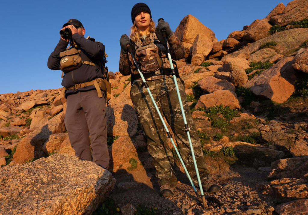 Ty Woodward, a Colorado Parks and Wildlife terrestrial biologist, left, and volunteer Cassidy English watch bighorn sheep below the summit of 14,115-foot Pikes Peak Wednesday, Aug. 5, 2026, as CPW conducts the second day of surveying the sheep population on the mountain. Woodward, other CPW biologists, wildlife officers and more than 40 trained volunteers spent the early hours surveying the sheep population on the mountain. (Christian Murdock, The Gazette)