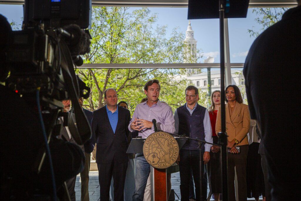 Mayor Mike Johnston speaks in front of Gov. Jared Polis, Alterra Mountain Co. Chief Customer Officer and Ikon Pass President David Flueck on Thursday, Sept. 3, 2026 at the former Denver Post building to announce Alterra's new headquarters. (Bernadette Berdychowski / The Denver Gazette)