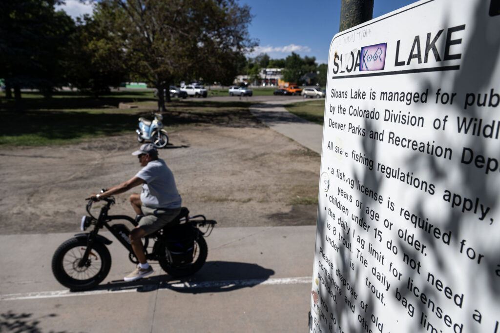 People walk along the path at Sloan’s Lake on Wednesday, Sept. 2, 2026. Mayor Mike Johnston announced a plan to revitalize the lake.