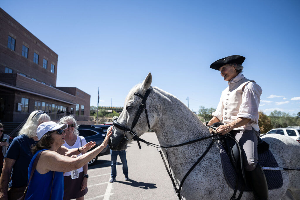 Carolyn Williamson, dressed as “Paula Revere” rides her horse Stormy in front of the Douglas county Building in Castle Rock during a protest on Thursday, Sept. 3, 2026 against the commissioners changing the title of a ballot initiative in a way protesters argue is deceptive.