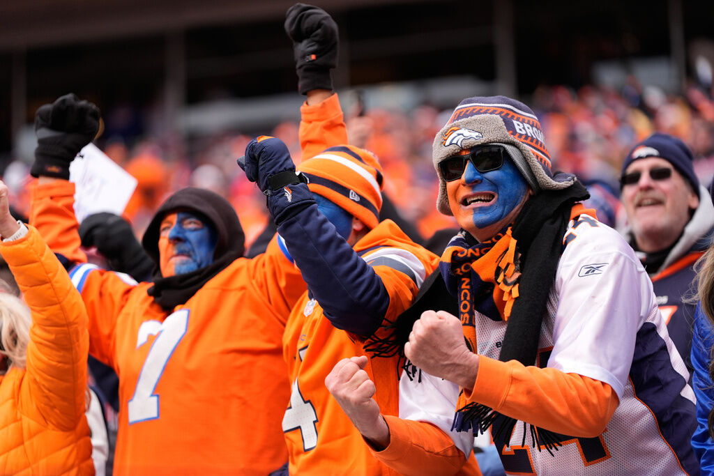 Denver Broncos fans cheer after a touchdown during the first half of an NFL football game against the New England Patriots Tuesday, Jan. 27, 2026, in Denver. (AP Photo/Ashley Landis)