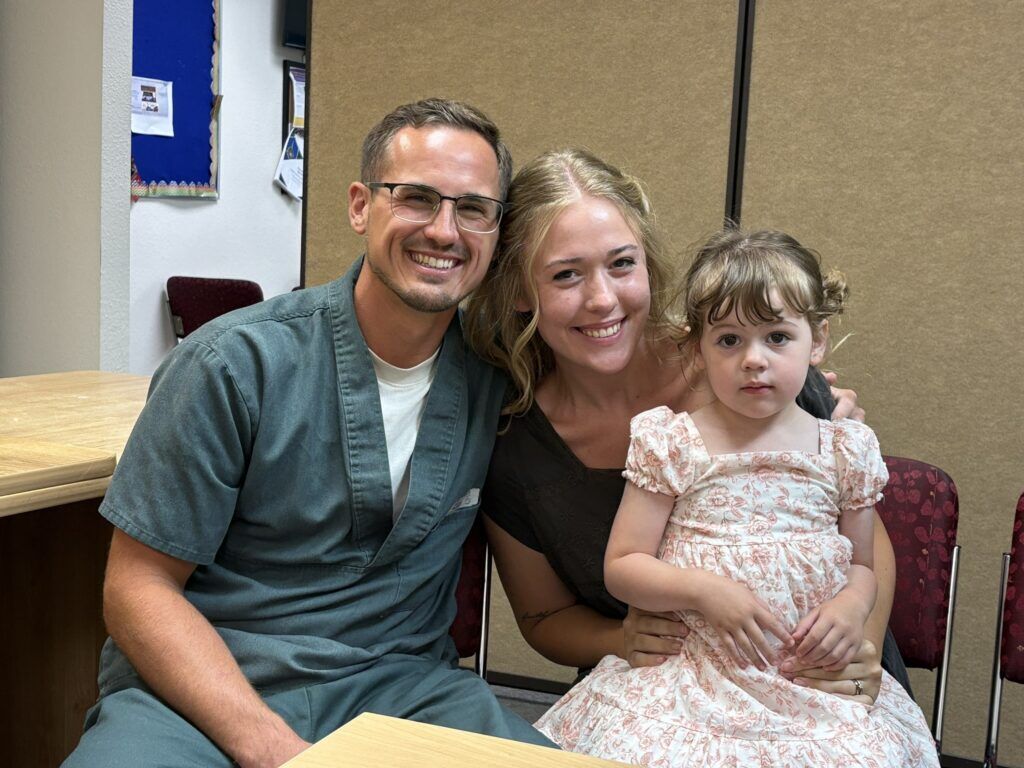 Anthony Notary with wife Corinn and daughter at Trinidad Correctional Facility. (Marianne Goodland, Colorado Politics)