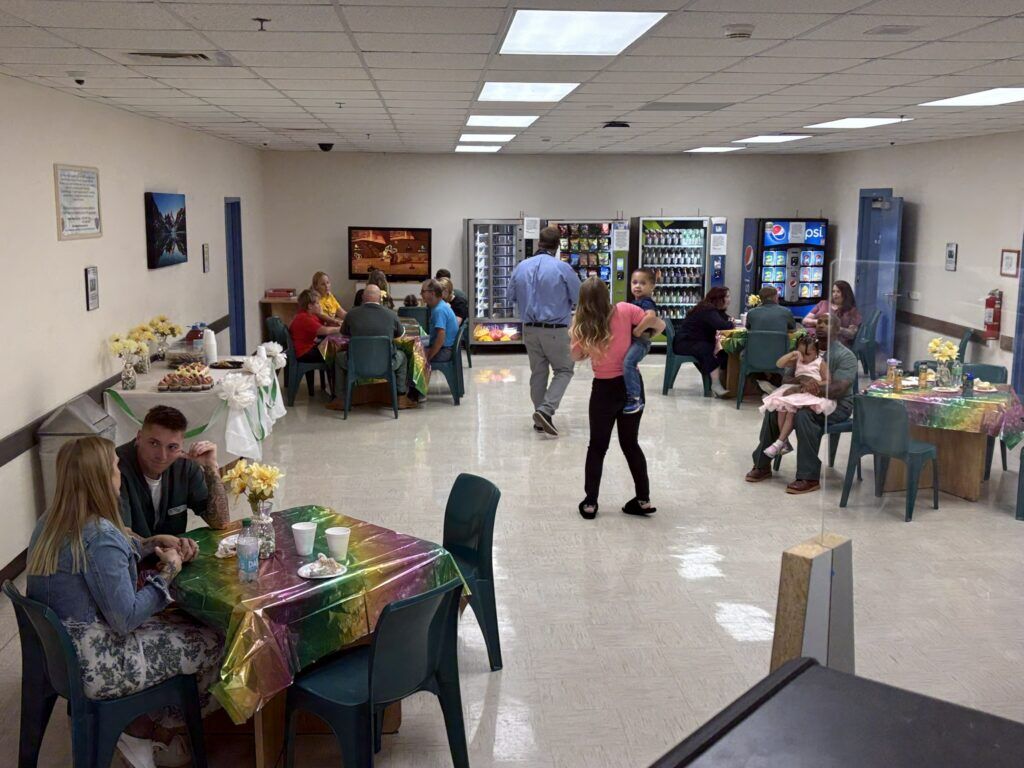 Fathers interact with their children and wives during a father/daughter dance at Trinidad Correctional Facility. (Marianne Goodland, Colorado Politics)