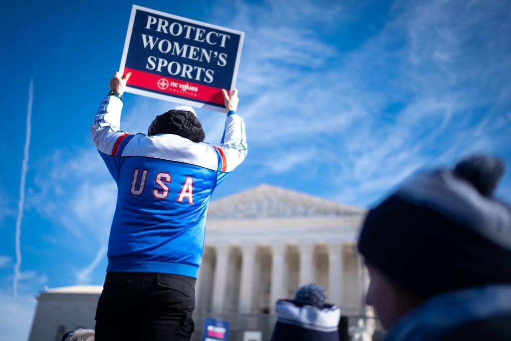 Demonstrators outside the Supreme Court during arguments of transgender sports cases.